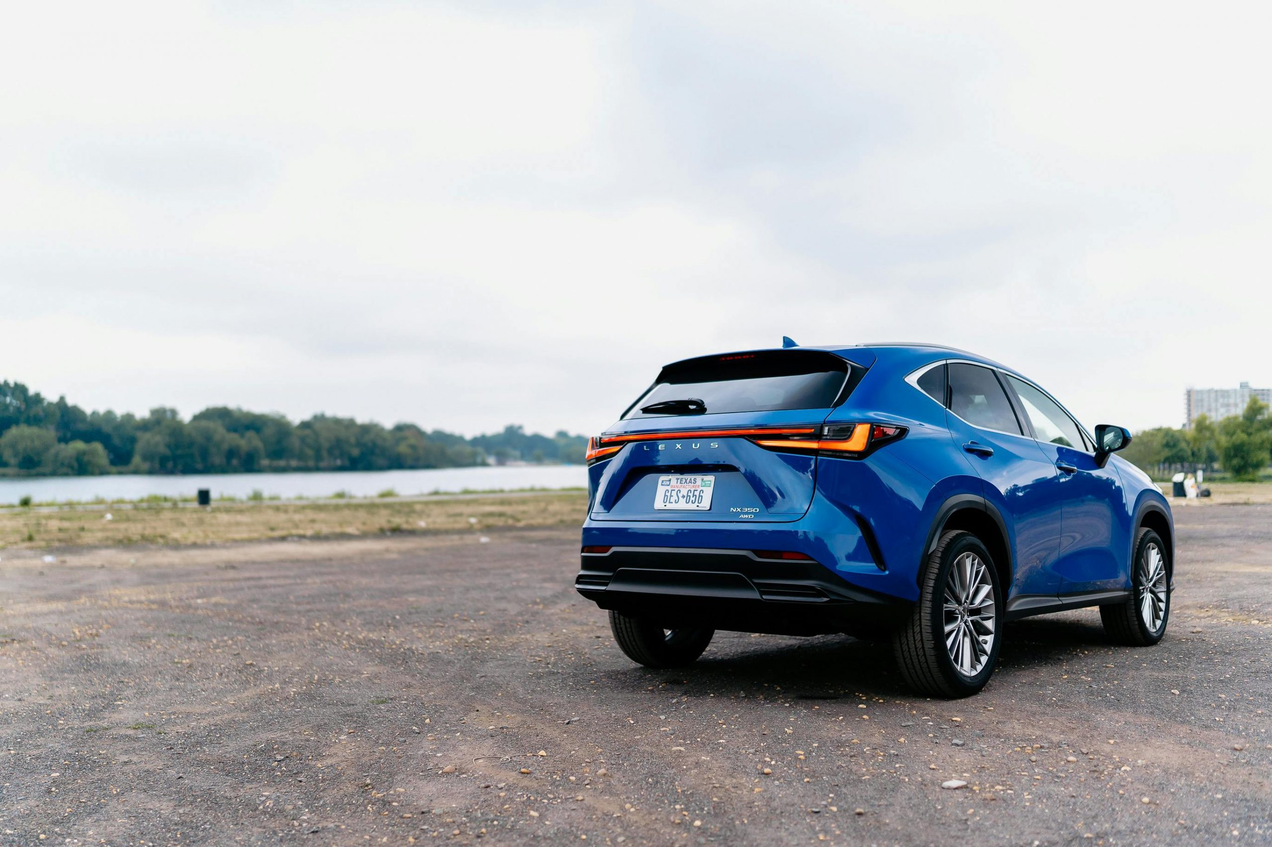 blue Lexus car parked by a lake
